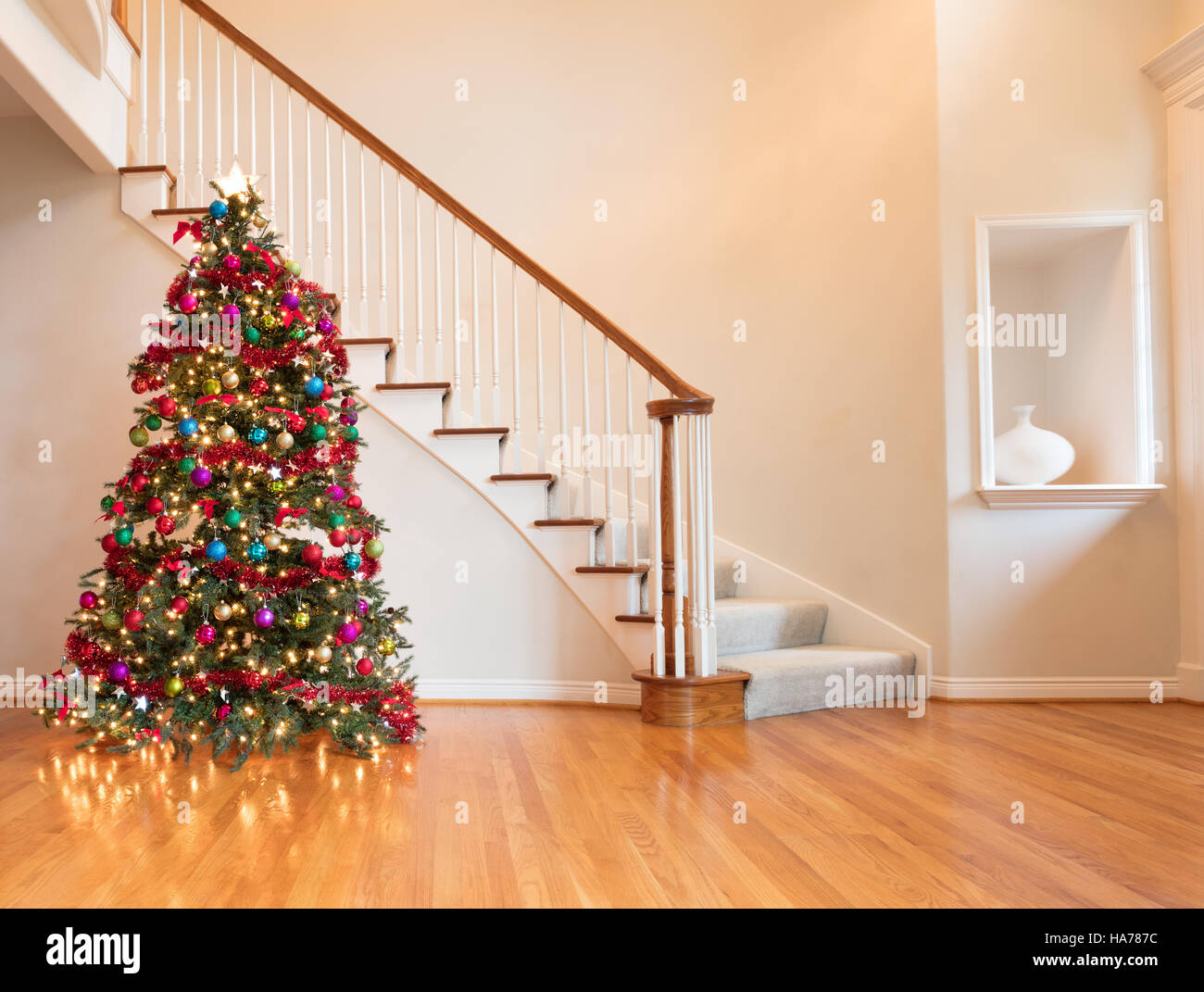 fully decorated christmas on wooden floor with staircase in background stock image - Fully Decorated Christmas Tree fully decorated christmas on wooden floor with staircase in background stock image - Fully Decorated Christmas Tree