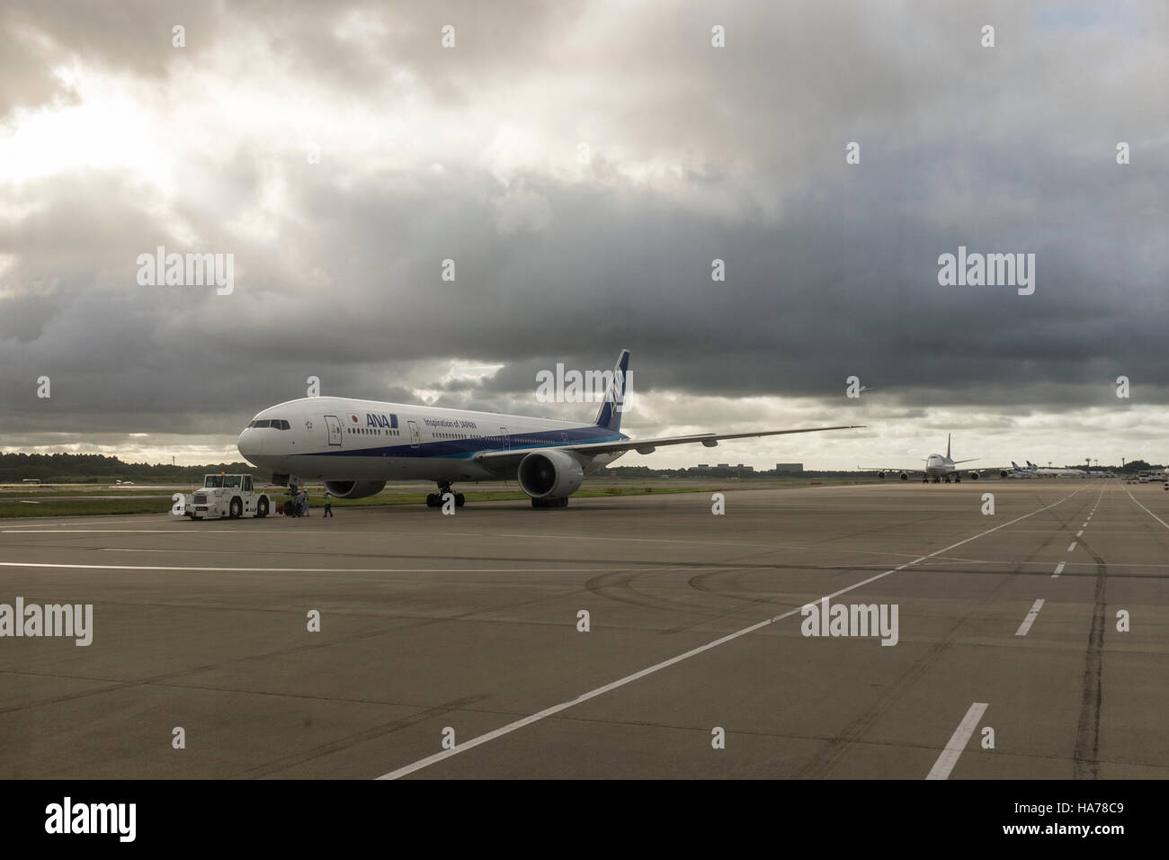 An ANA aircraft on the tarmac with gloomy skies, at Narita airport, Japan. Stock Photo