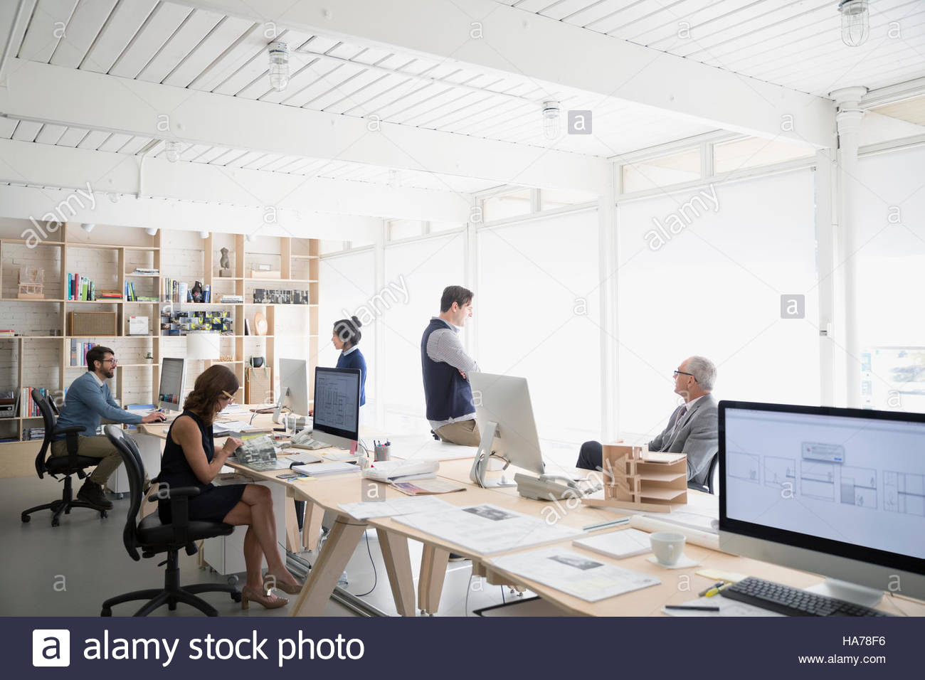 Architects working at computers in open plan office Stock Photo - Alamy