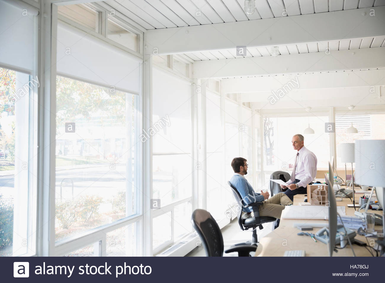 Male architects talking in open plan office Stock Photo Alamy
