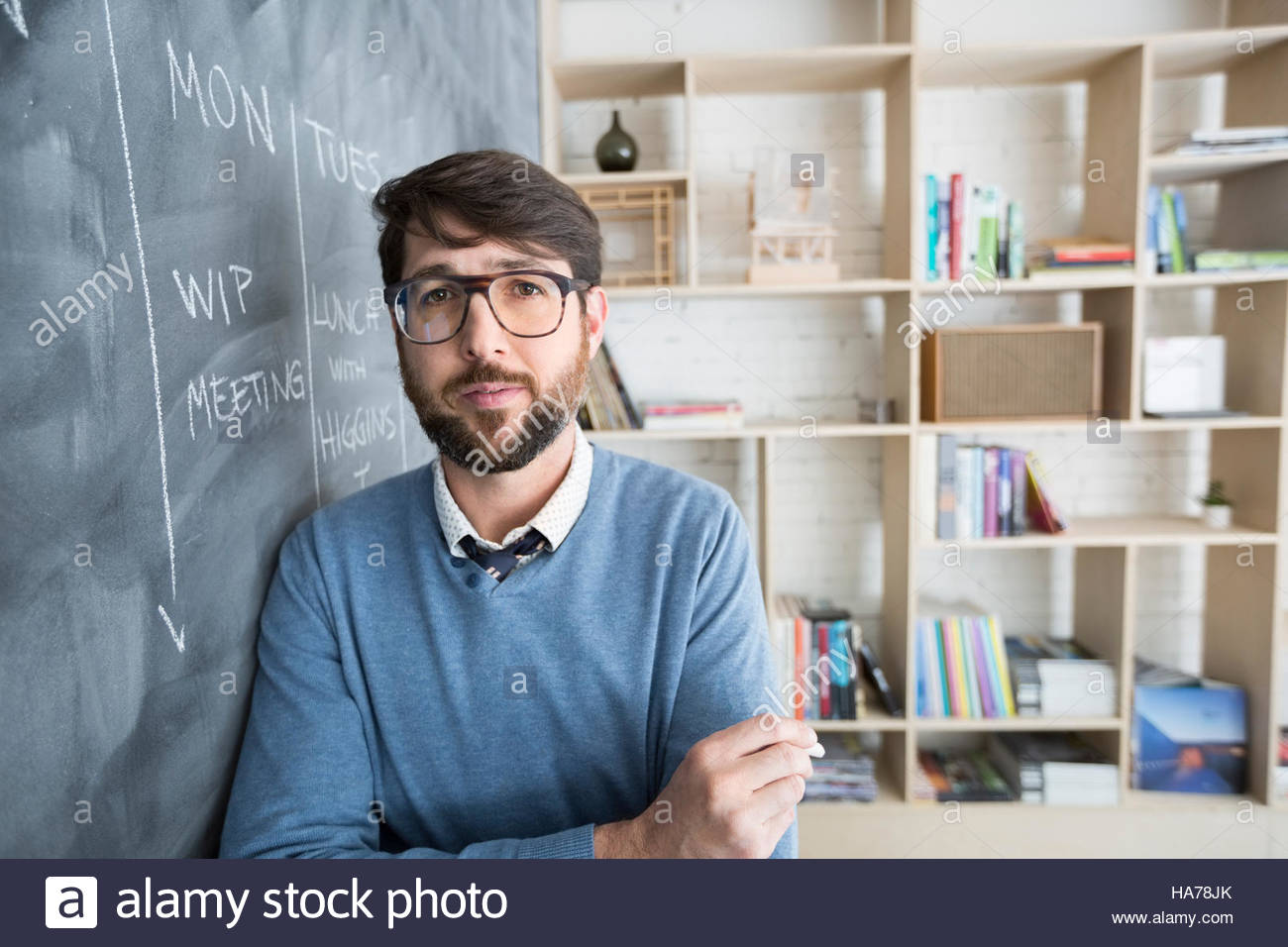 Portrait confident businessman scheduling at blackboard Stock Photo