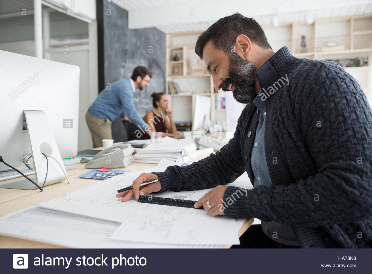 Male architect drafting blueprint with ruler in office Stock Photo Alamy