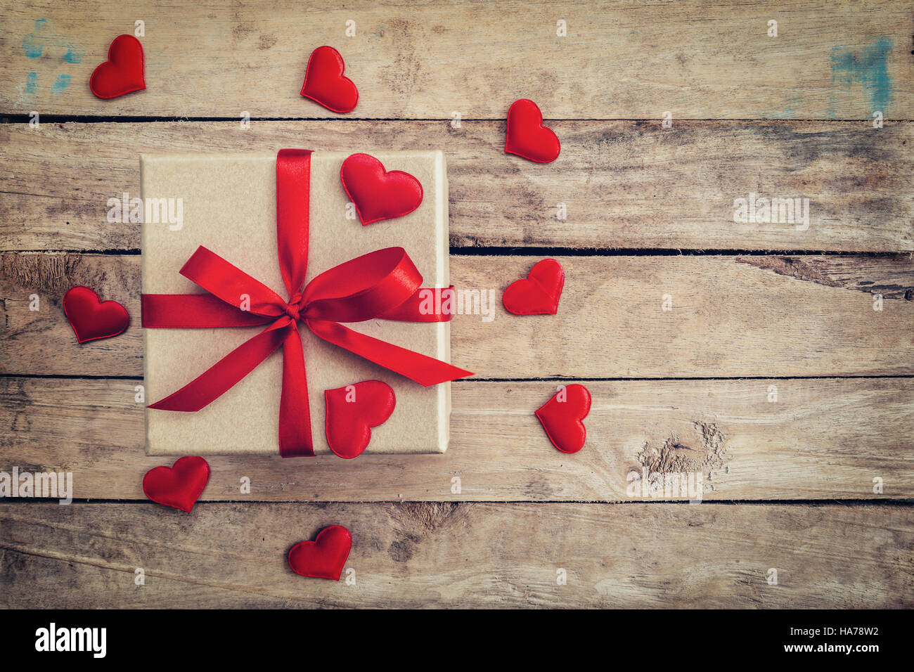 Top view (above) gift box and red ribbon and red heart for valentine on table wooden. Valentine background. Stock Photo