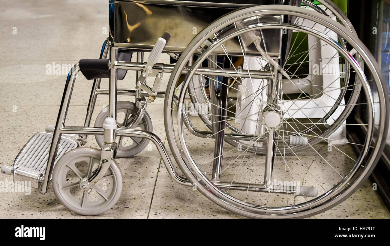 Empty wheelchair parked in hospital Stock Photo