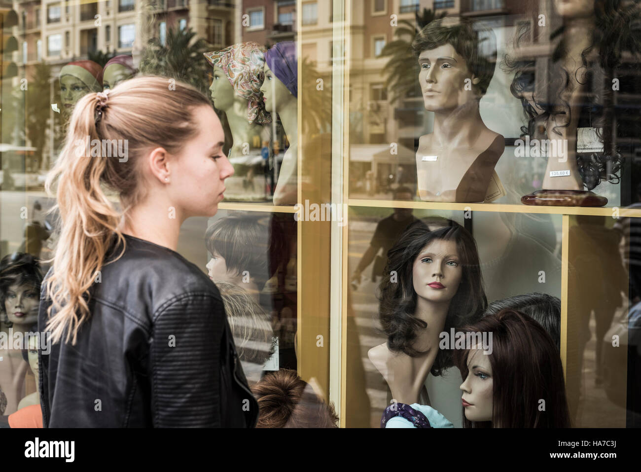 Teenager looking at a shop window, Malaga, Andalusia, Spain. Stock Photo