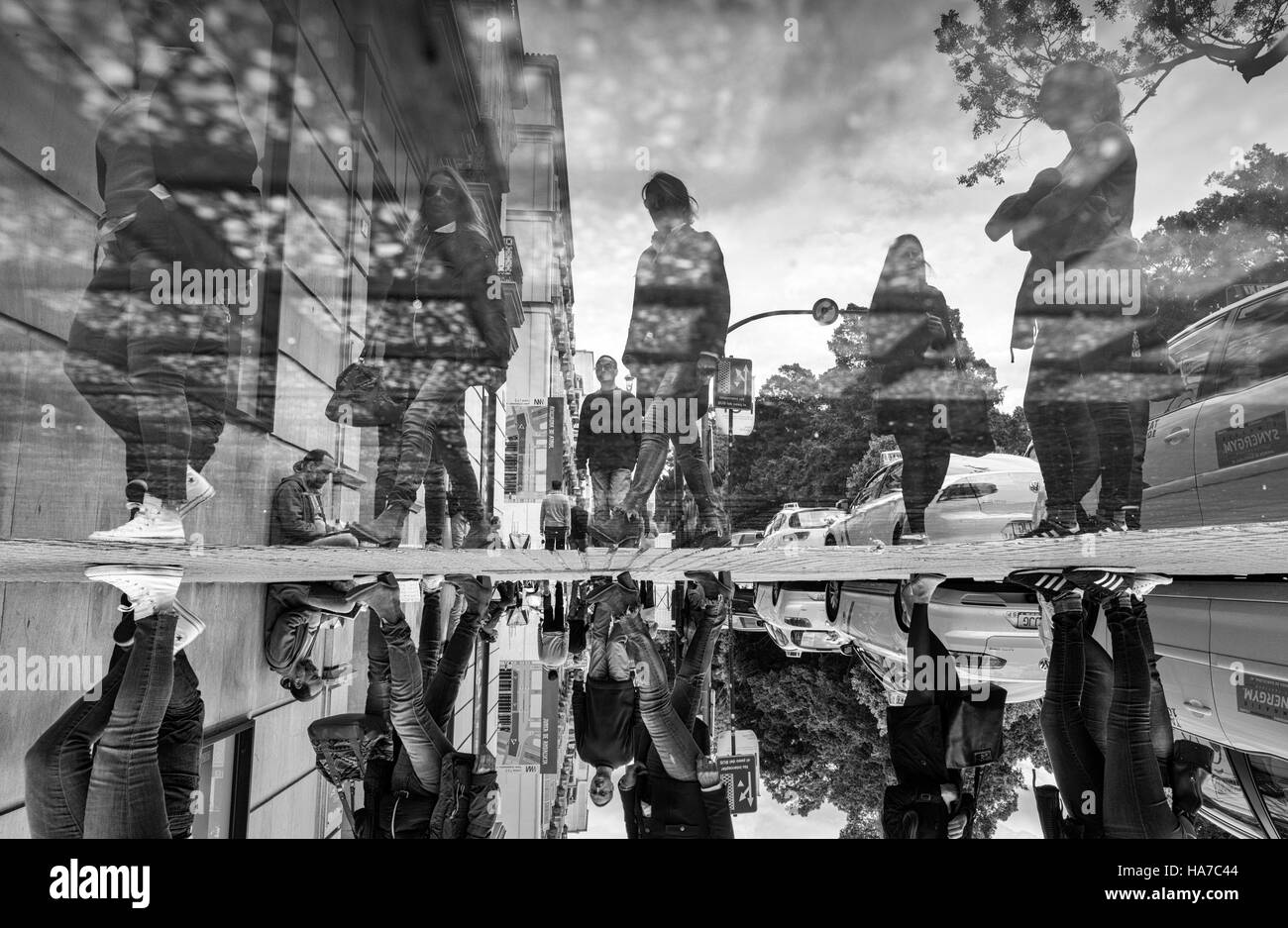 People reflected in water. Malaga, Andalusia, Spain. Stock Photo