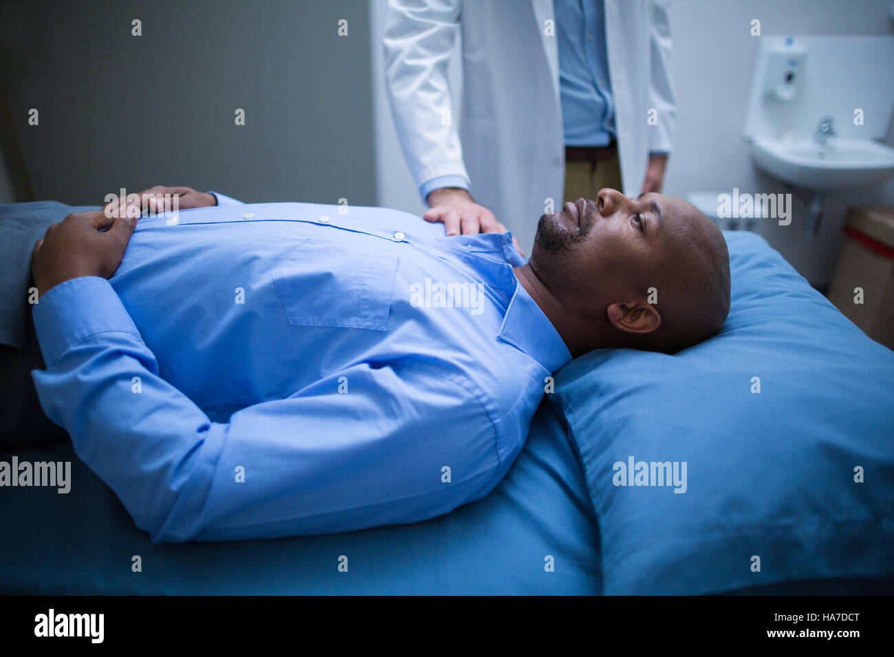 doctor-consoling-a-patient-on-bed-stock-photo-alamy