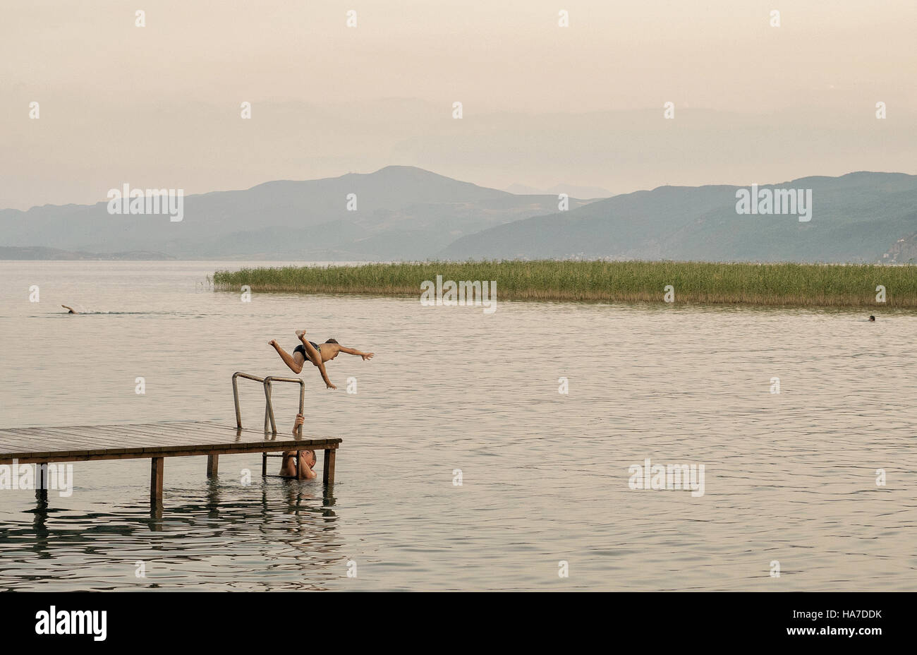 A boy is jumping in the lake, Stock Photo