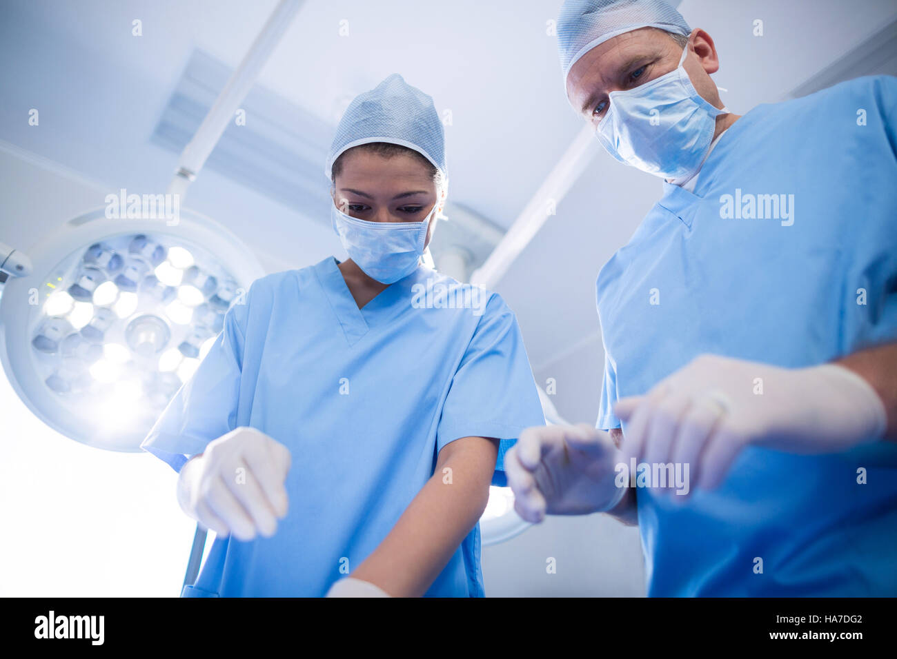 Group of surgeons performing operation in operation room Stock Photo ...