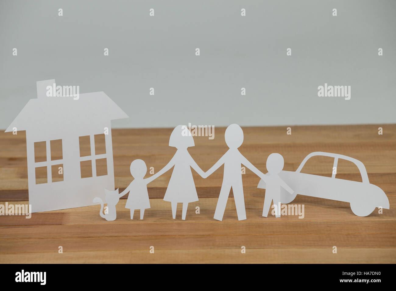 Paper cutout family with house and car Stock Photo