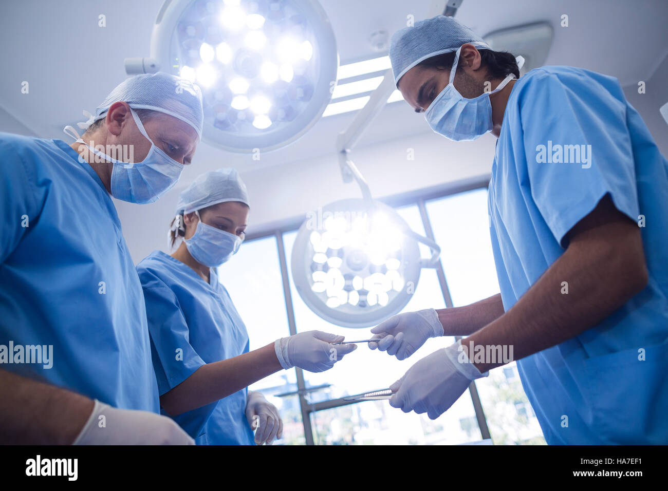 Group of surgeons performing operation in operation room Stock Photo ...