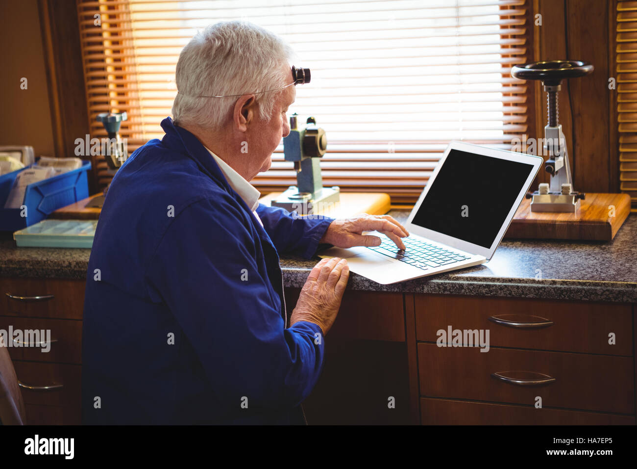 Horologist working on laptop Stock Photo Alamy