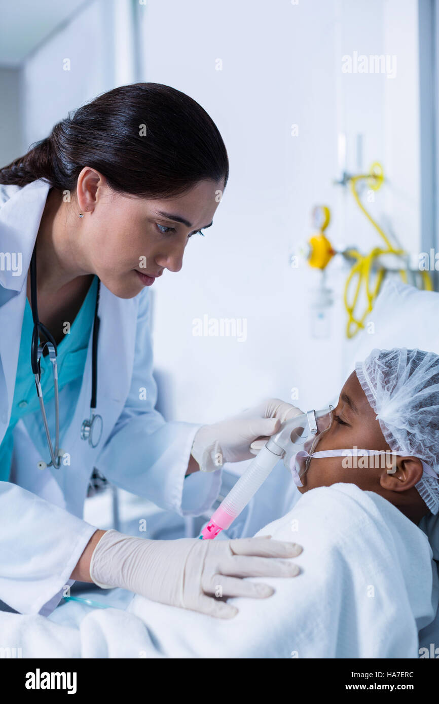 Doctor placing an oxygen mask on patient Stock Photo Alamy