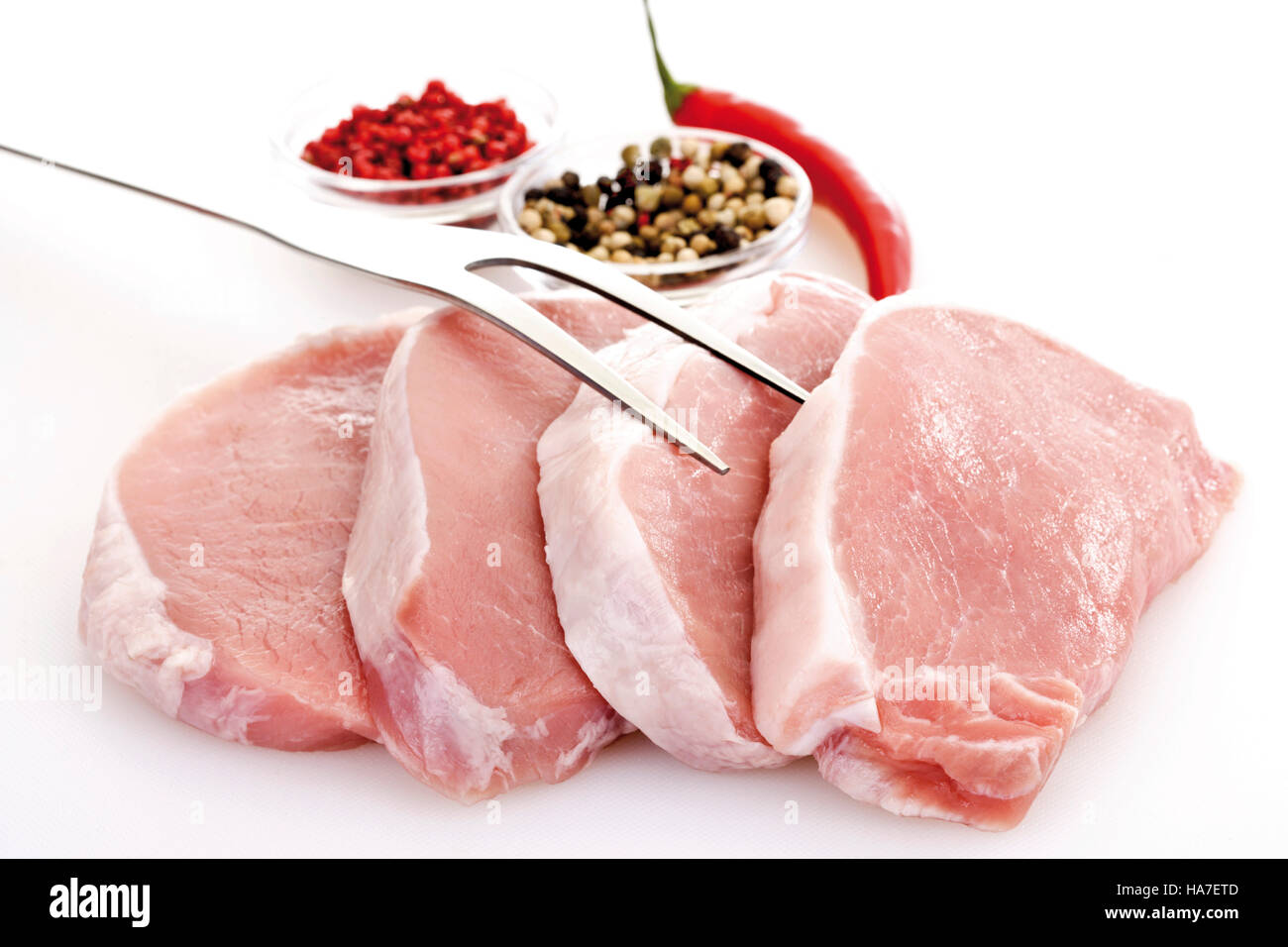 Saddle steaks, raw with a meat fork and ingredients Stock Photo Alamy