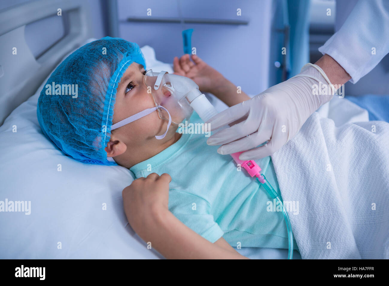 Doctor placing an oxygen mask on patient in ward Stock Photo Alamy