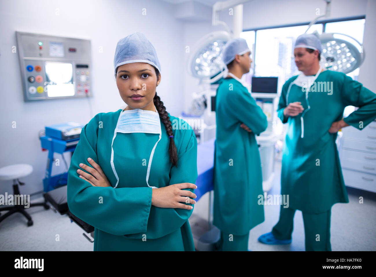 Portrait of smiling doctor standing with arms crossed Stock Photo - Alamy