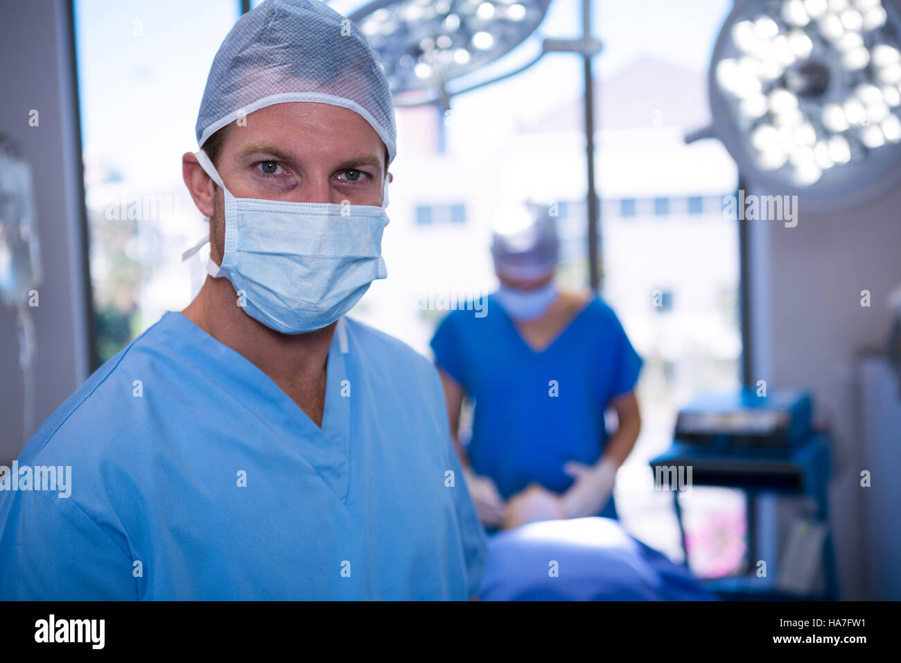 Portrait of male nurse wearing surgical mask in operation theater Stock ...