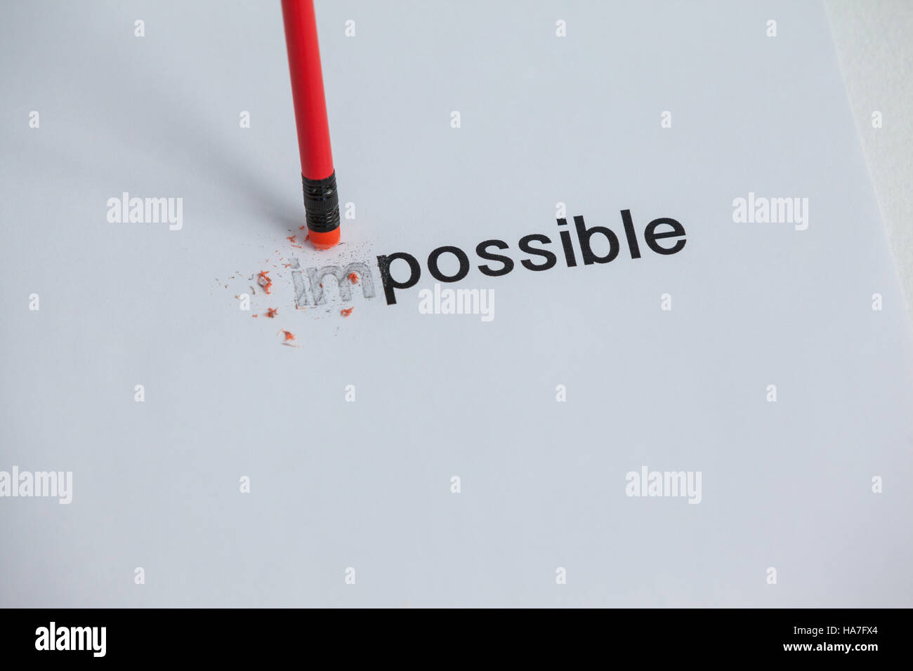 Changing the word impossible to possible with a pencil eraser Stock Photo