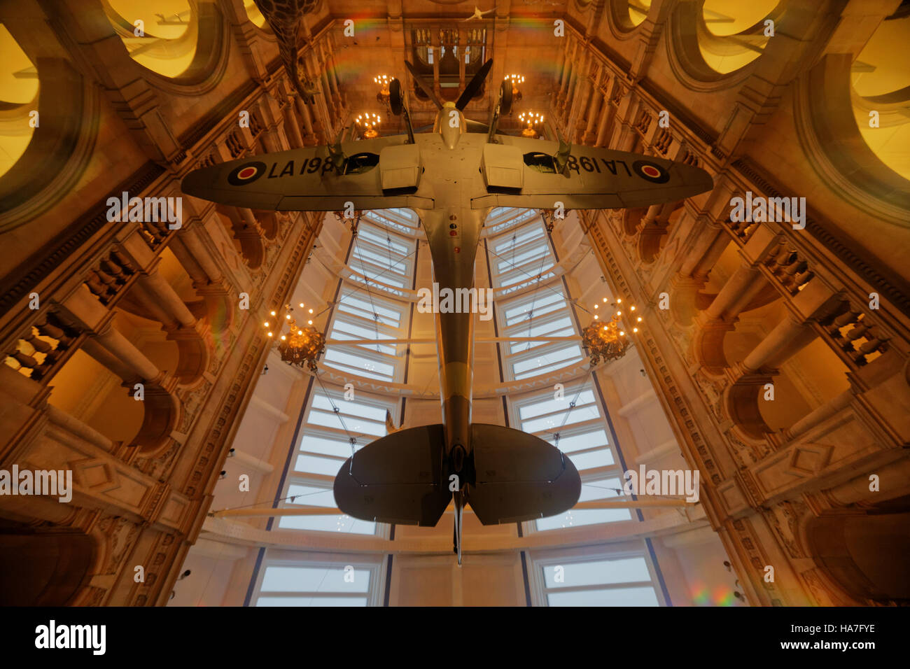 Glasgow Kelvingrove museum interior inside the galleries spitfire war plane hanging from ceiling viewed from below Stock Photo
