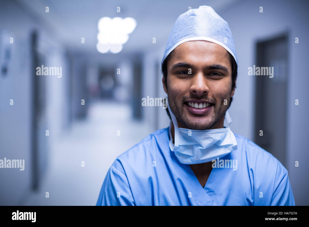 Portrait of smiling male surgeon standing in corridor Stock Photo - Alamy