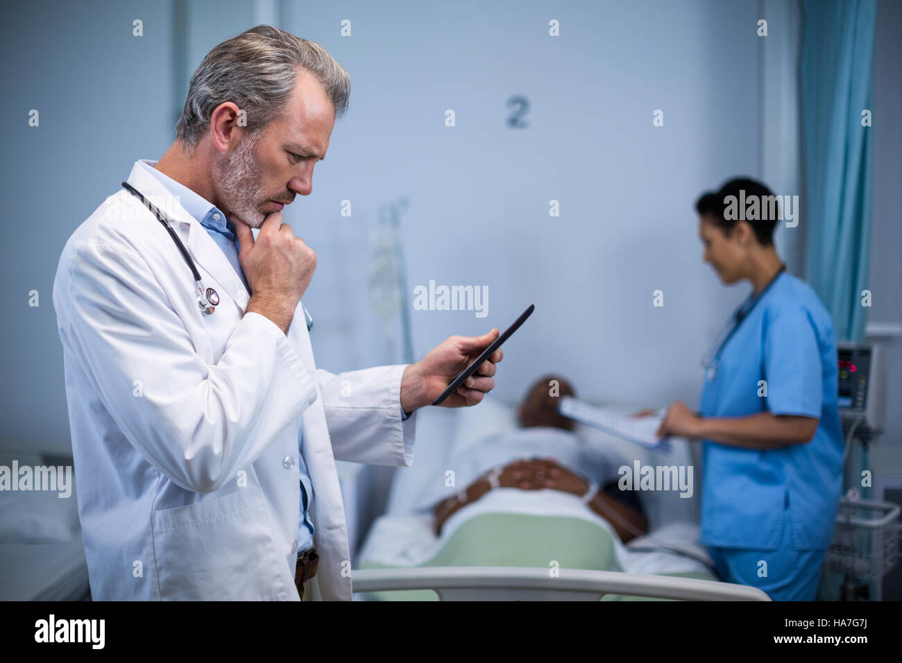 Doctor man thinking tablet hi-res stock photography and images - Alamy