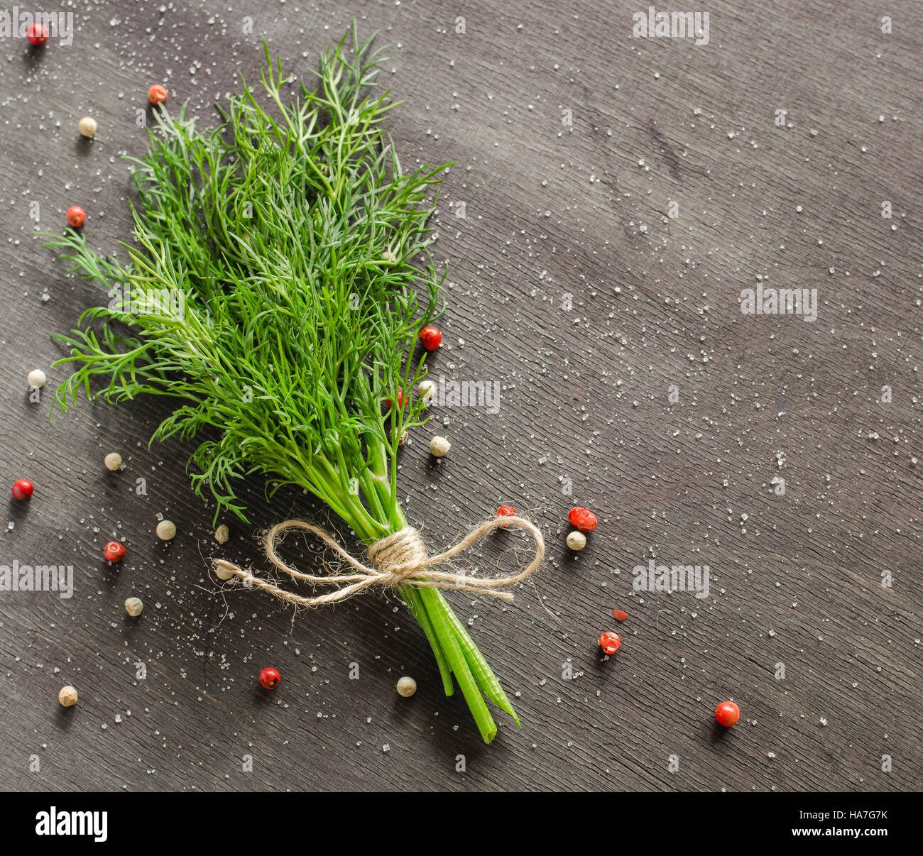 A bunch of fresh dill on dark wood background. Empty space for text ...