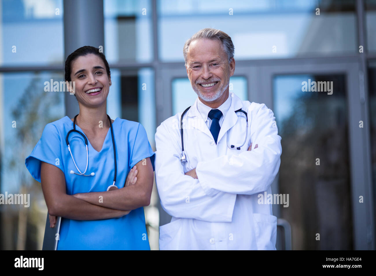 Portrait of doctor and nurse standing with arms crossed Stock Photo - Alamy