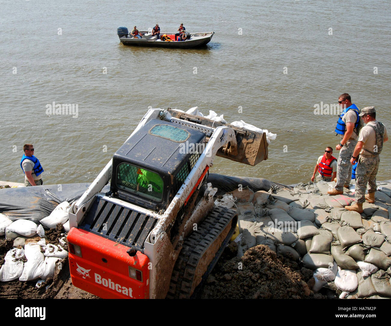 National Guard soldiers assist with flood management in Dakota Dunes, South Dakota, following the 2011 Missouri River flooding. Their efforts support local communities and ensure public safety during extreme weather events. Stock Photo