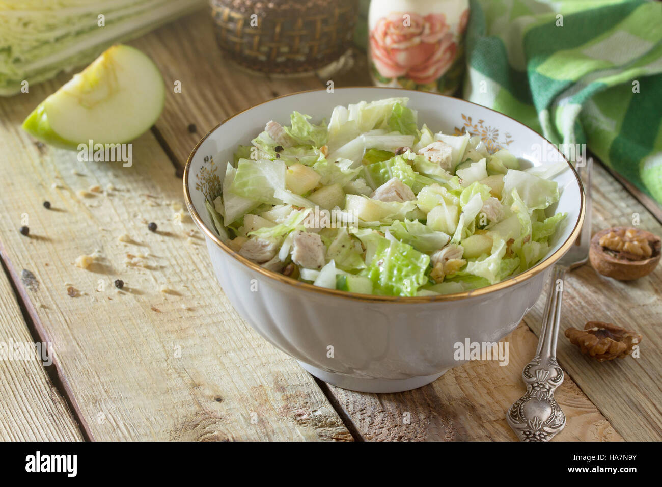 Salad with cabbage, chicken, apple, cucumber and walnuts. Healthy food concept. Top view. Stock Photo