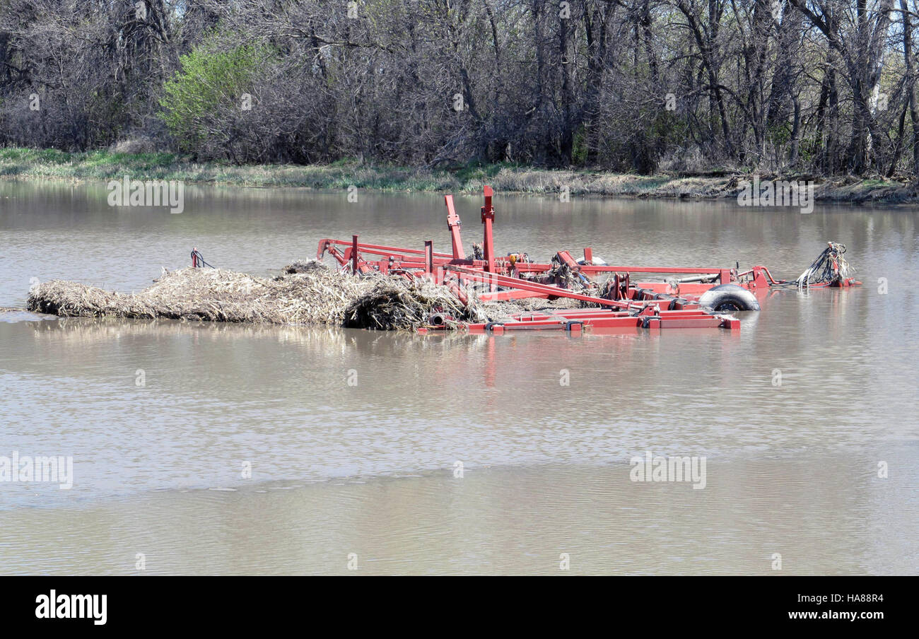 This image depicts flooding in the Cavalier and Tongue River watersheds, showing the impact of erosion on farmland in North Dakota. It highlights road damage and flooded fields, illustrating the effects of natural disasters on agricultural areas. Stock Photo