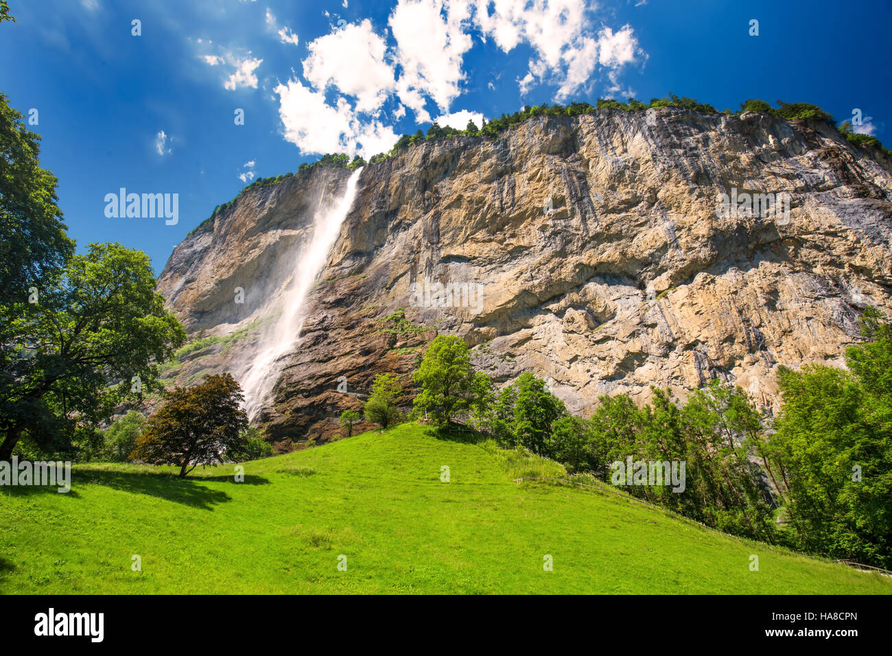 Famous Lauterbrunnen valley with gorgeous waterfall and Swiss Alps in the background, Berner Oberland, Switzerland, Europe. Stock Photo