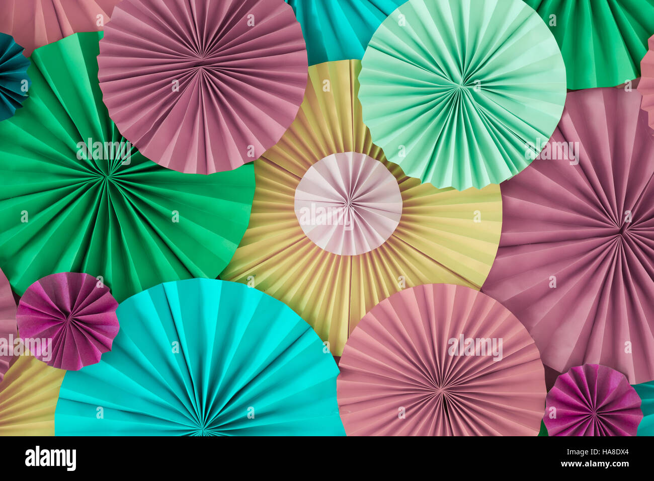 Colorful celebration background wall with multicolored paper circles of pink, lilac, yellow, green and blue colors Stock Photo