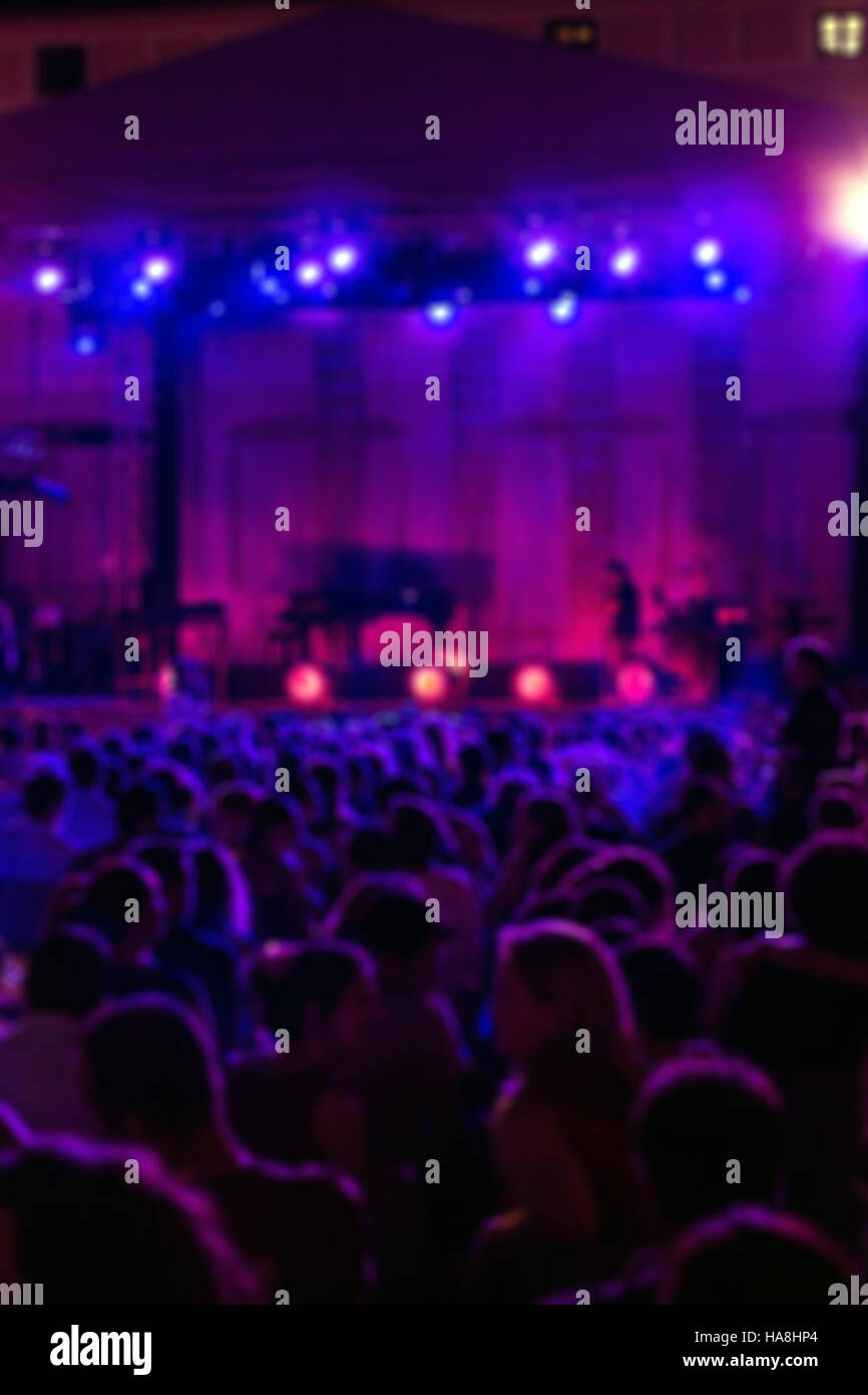 Blurred Image of People at Music Concert, vertical Stock Photo