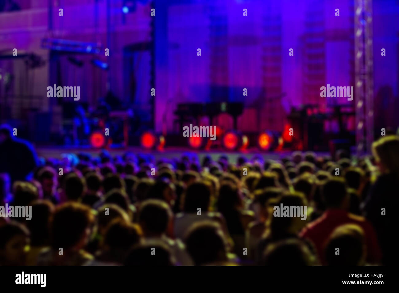 Blurred Image of People at Music Concert, with blue lights Stock Photo