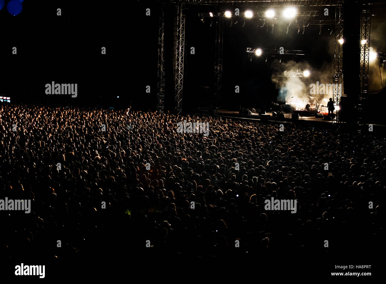 Thousands of People Crowd at night Rock Concert Stock Photo