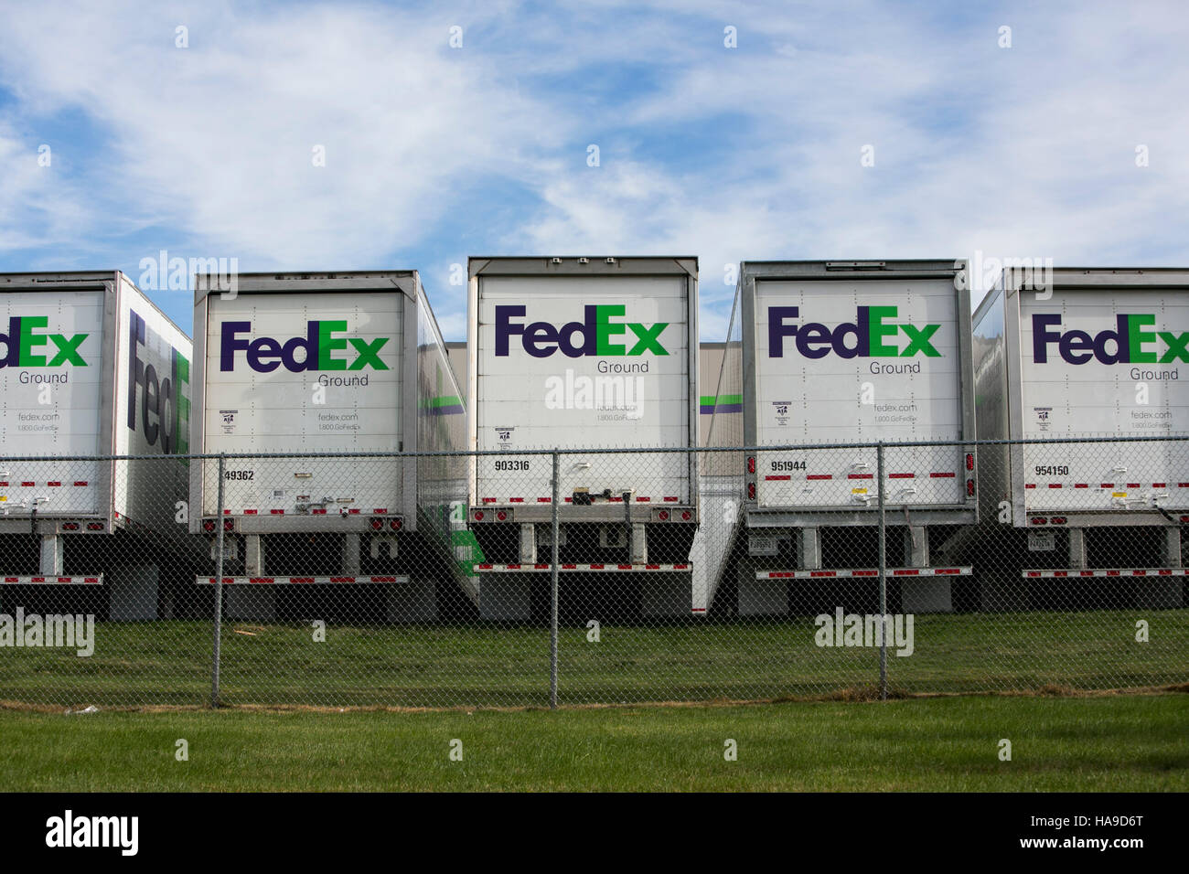 FedEx Ground logos on truck trailers lined up at a facility in Dayton
