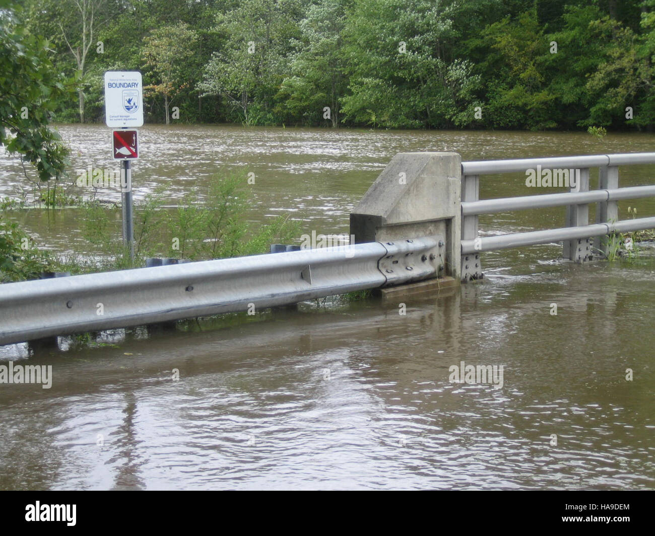 A flooded road at Great Swamp National Park highlights the impact of seasonal weather events on wetland ecosystems, demonstrating the park’s role in water management and wildlife protection. Stock Photo