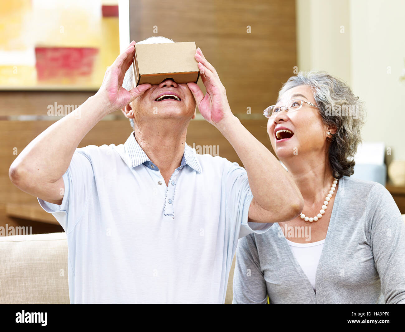 senior asian couple experiencing new technology by trying a vr device Stock Photo