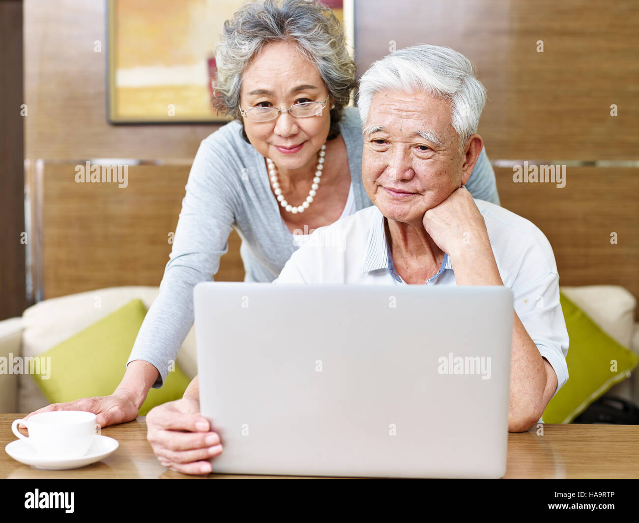 loving senior asian couple using a laptop computer together. Stock Photo