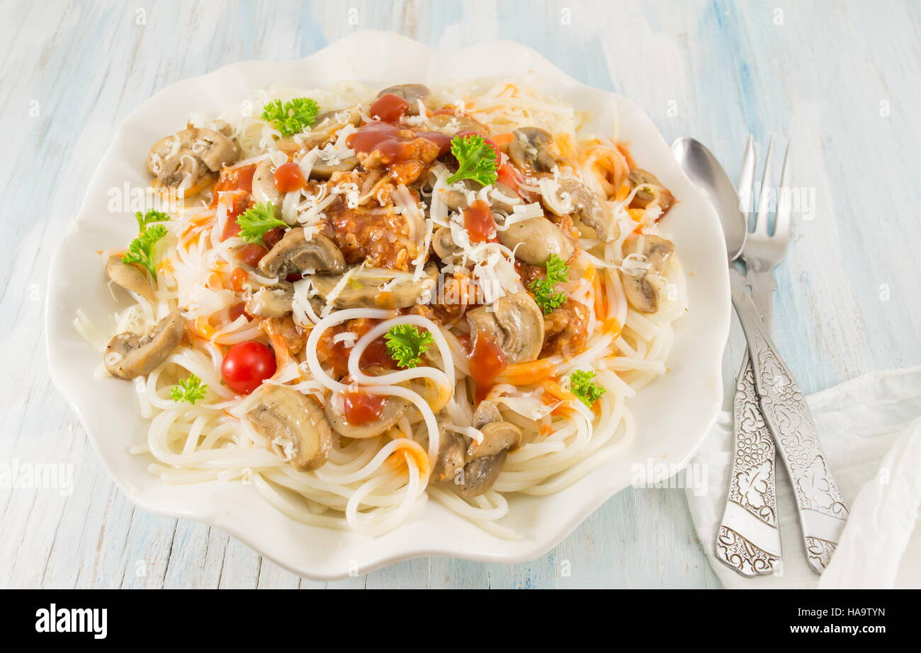 Pasta on a plate with mushrooms and cherry tomatoes Stock Photo