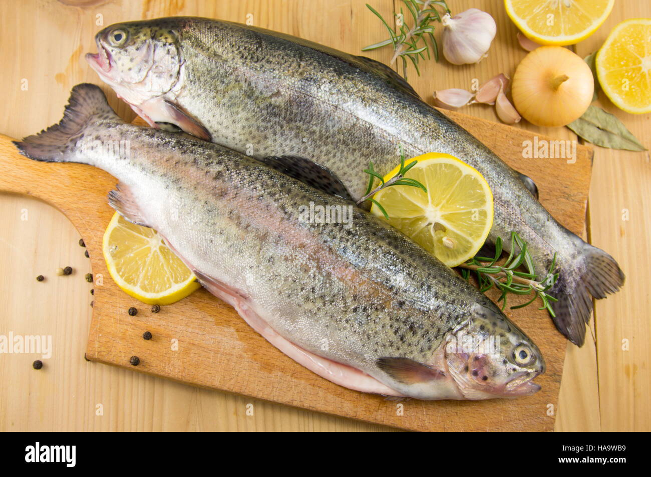 raw seasoned trout on a cutting board Stock Photo