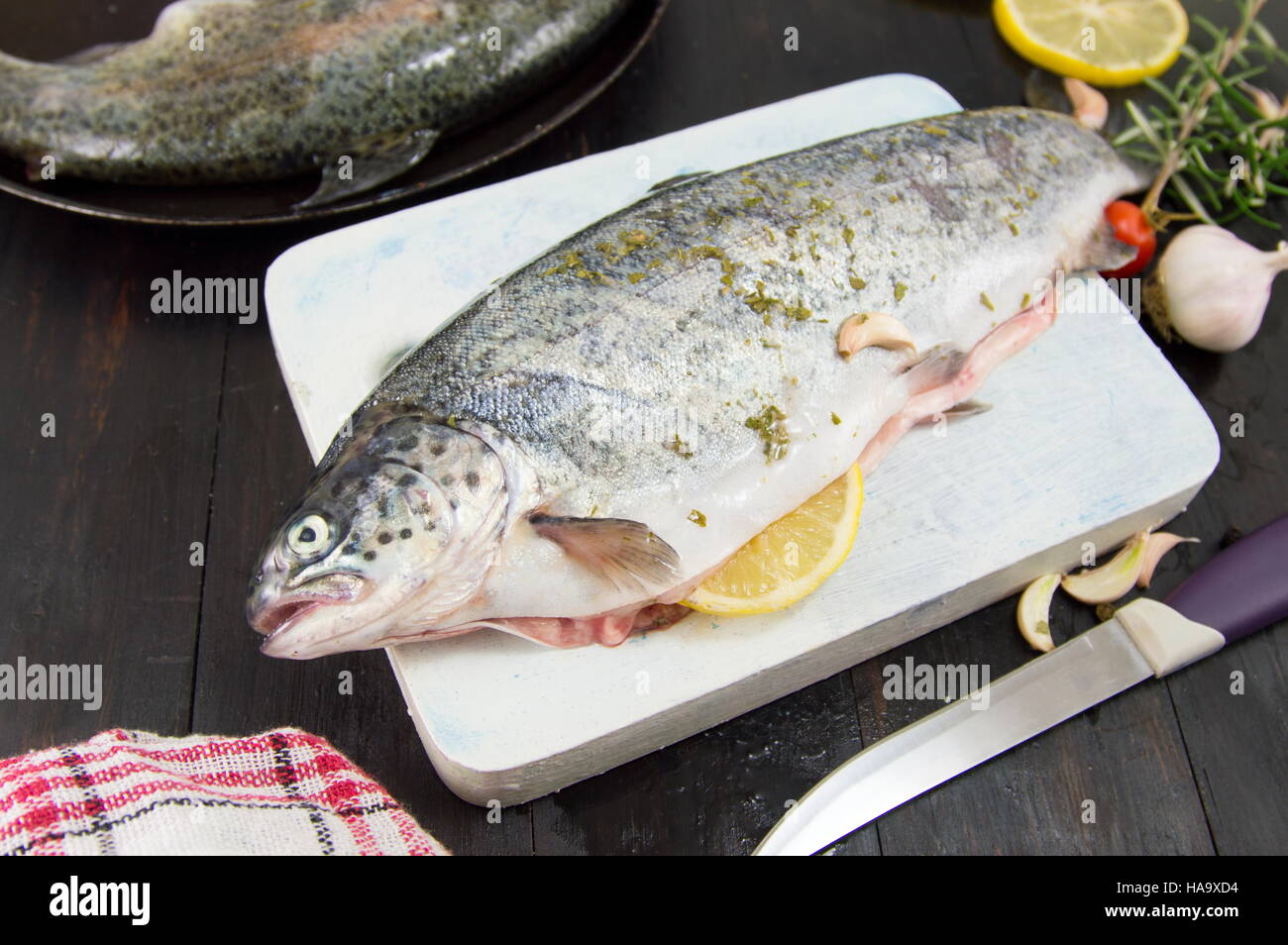 raw seasoned trout on a cutting board Stock Photo
