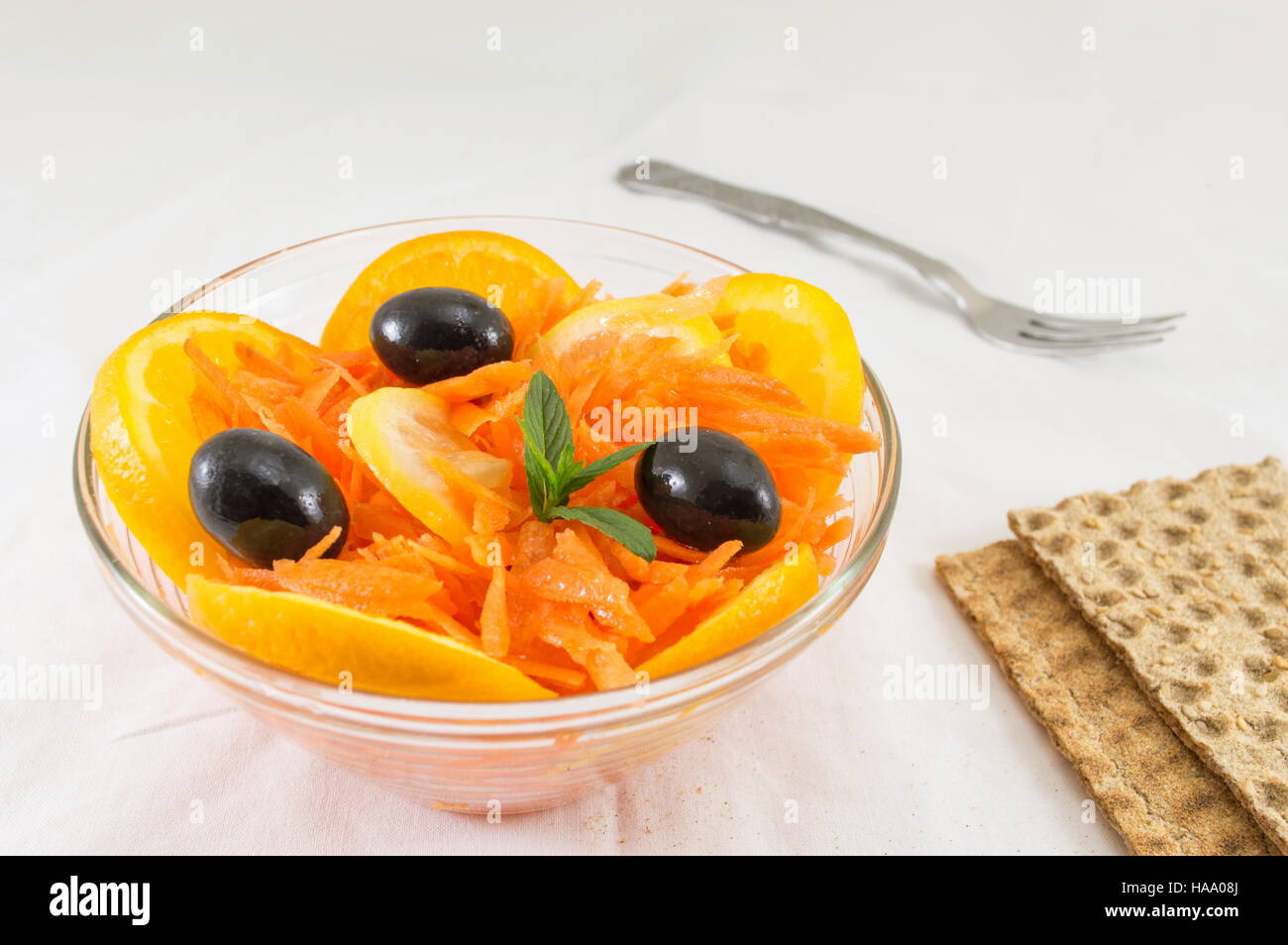 orange, carrot and olive salad with integral biscuits Stock Photo
