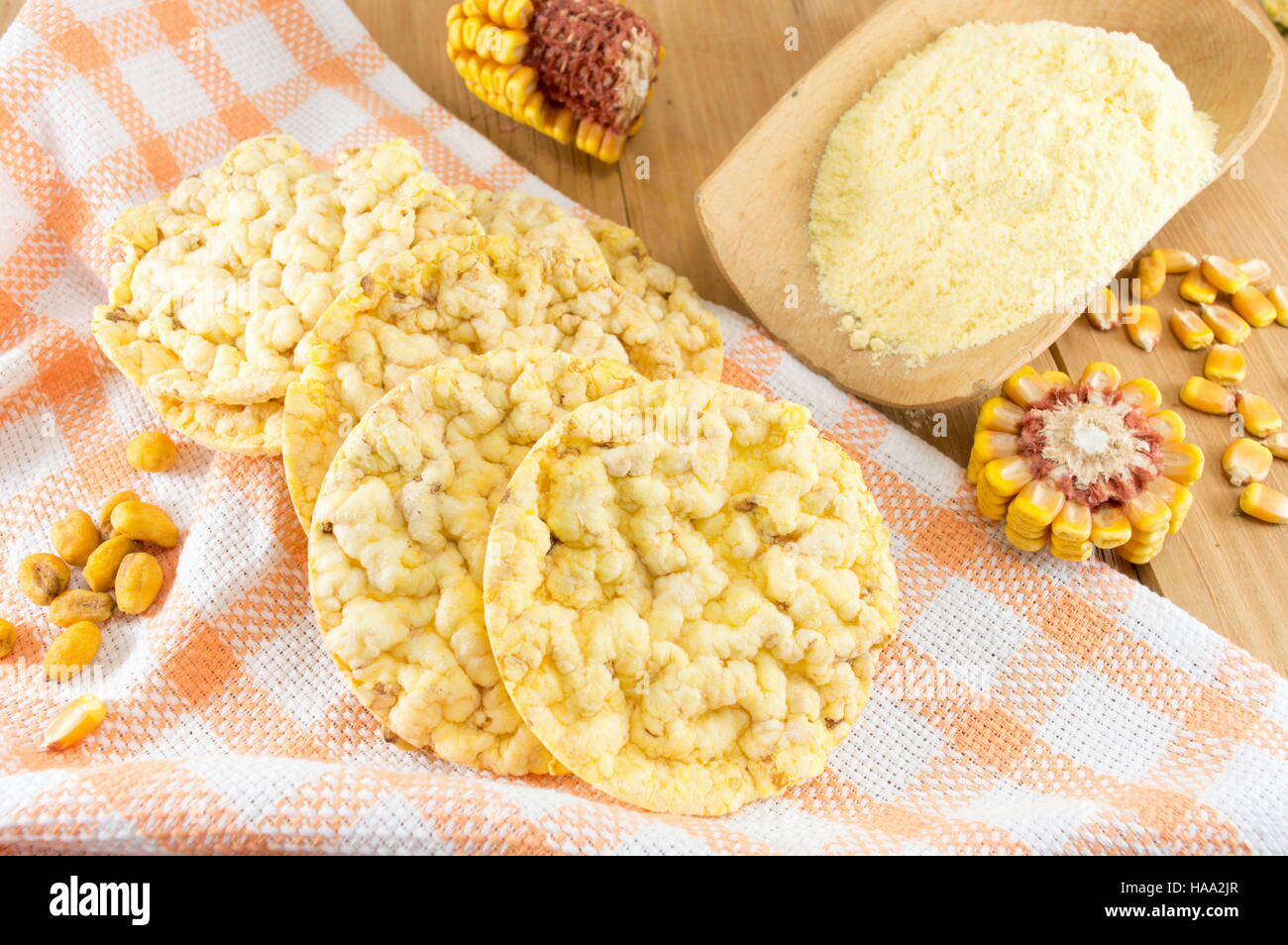 circle shaped corn snacks and corn kernels Stock Photo