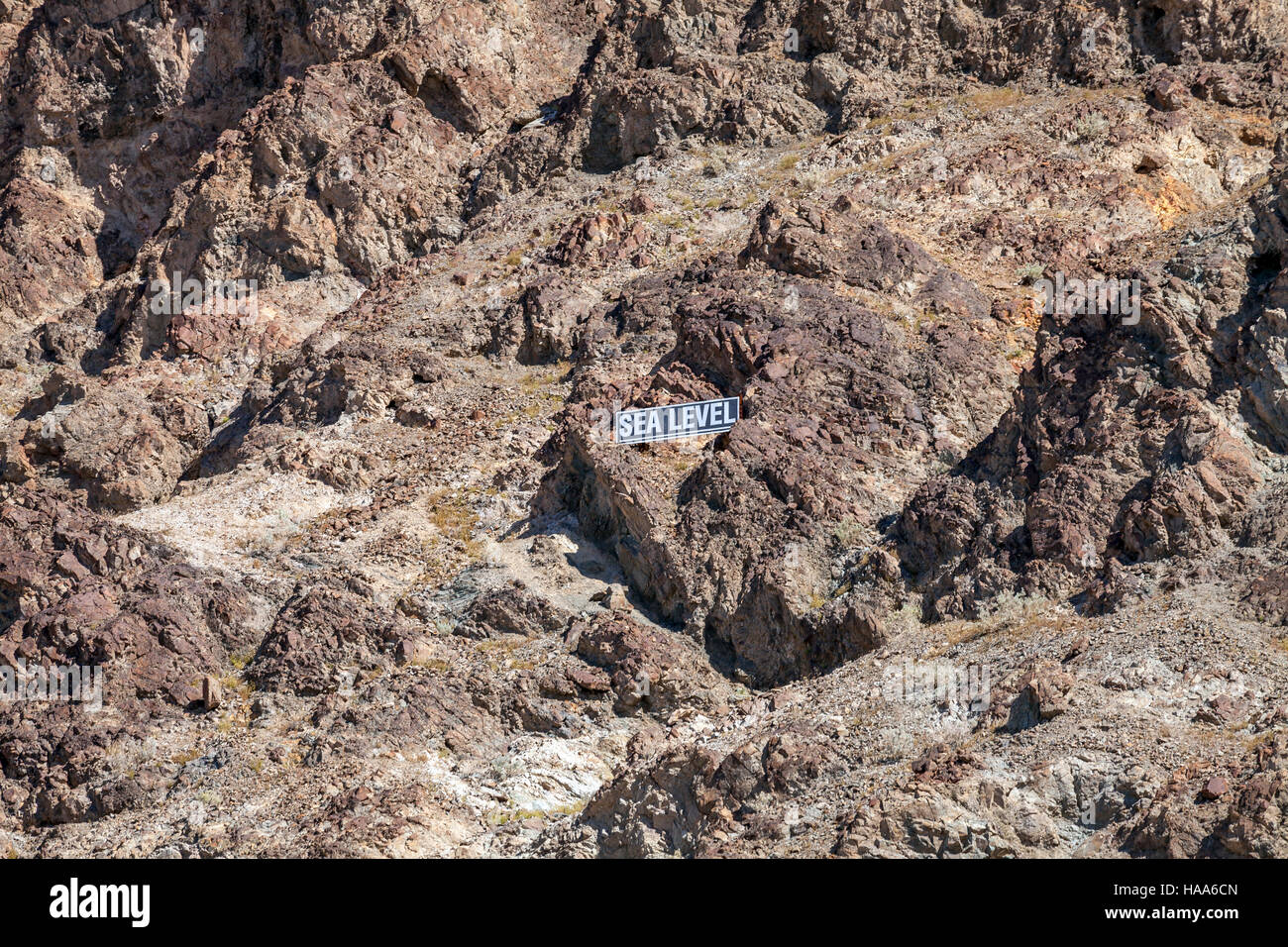 Sea Level sign on volcanic rock mountain,  Badwater Basin, Death Valley National Park, California, USA Stock Photo