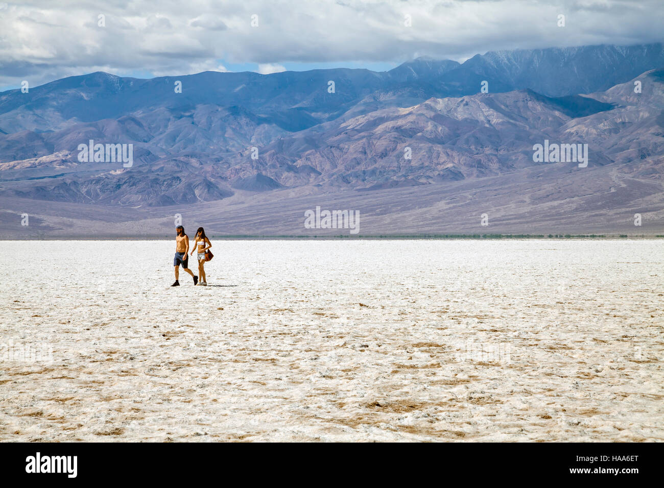 Couple walking in the middle of the Badwater Basin, Death Valley National Park, California, USA Stock Photo