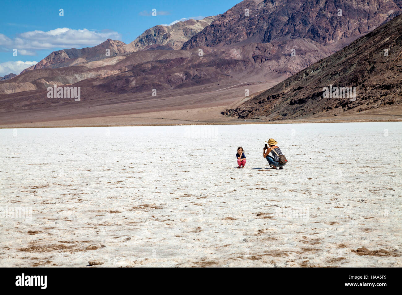 Mother photographing daughter, Badwater Basin, Death Valley National Park, California, USA Stock Photo