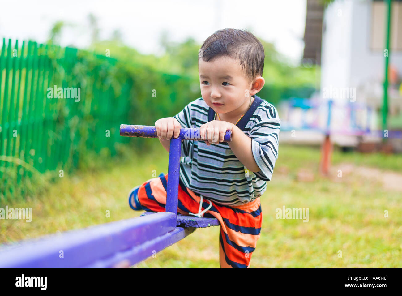 happy-kid-play-teeter-totter-in-kindergarten-or-preschool-shallow-dof