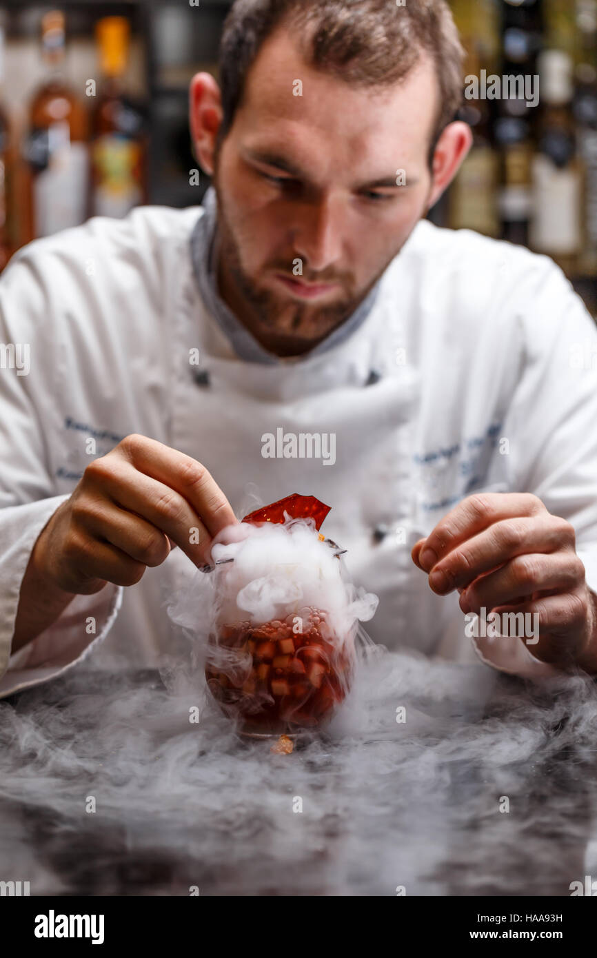Fruit soup with dry ice, Chef decorating Stock Photo