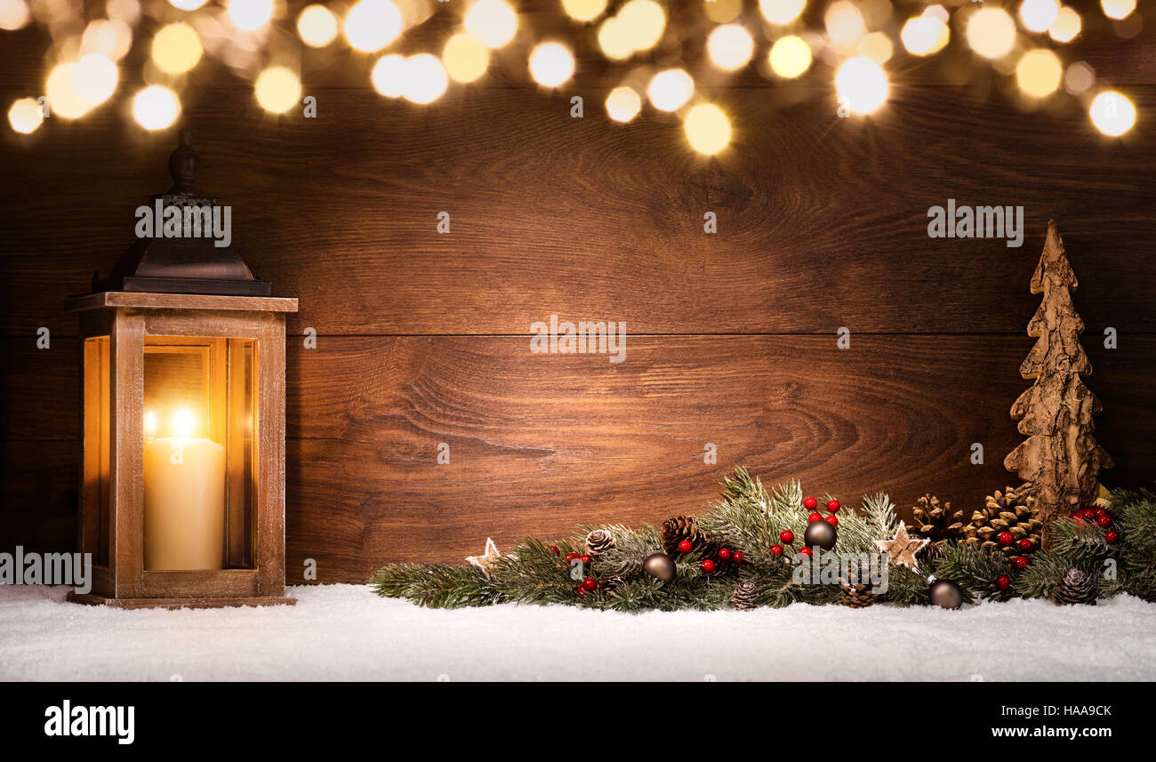 Christmas scene with a lantern, ornaments and blurred lights in front ...